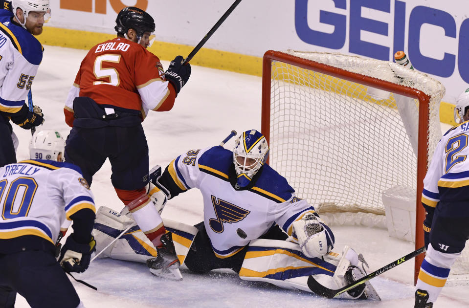 St. Louis Blues goaltender Ville Husso (35) stops the shot of Florida Panthers defenseman Aaron Ekblad (5) during the second period of an NHL hockey game Saturday, Dec. 4, 2021, in Sunrise, Fla. (AP Photo/Jim Rassol)