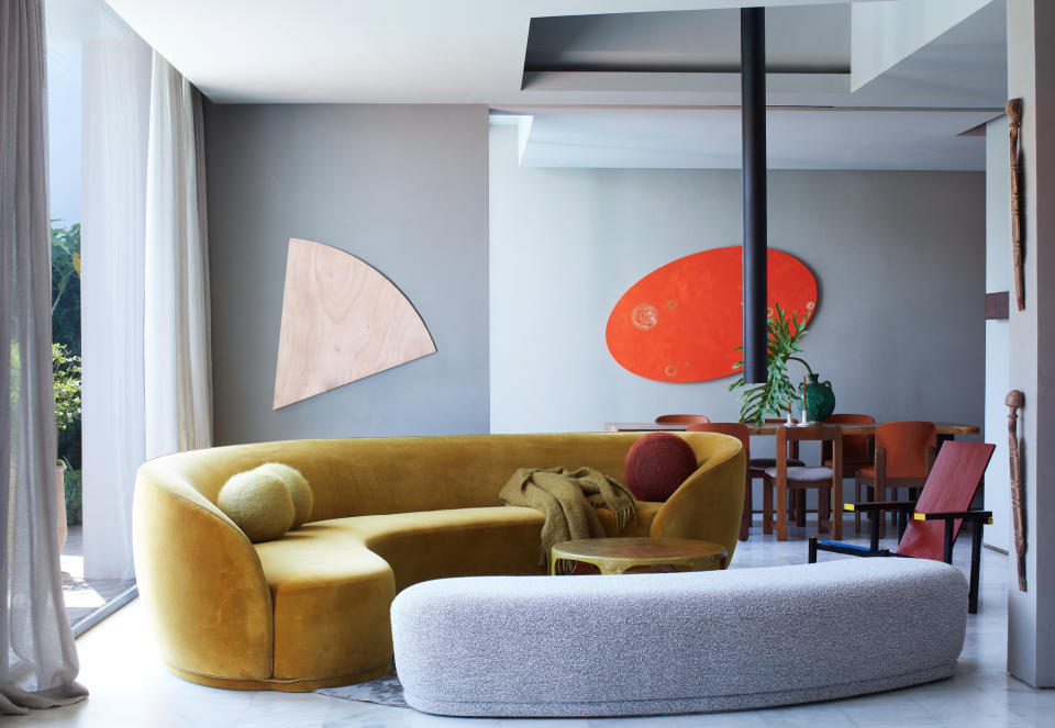 A living room with window treatment concealed into the ceiling