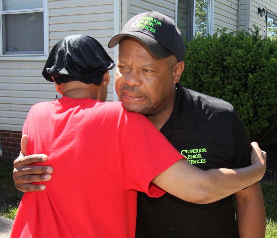 Rebecca Shepard, left, hugs Gerald Williams, who delivered packages of items that belonged to her late son. FedEx incorrectly delivered the packages to a property that Williams was selling instead the Shepard home.