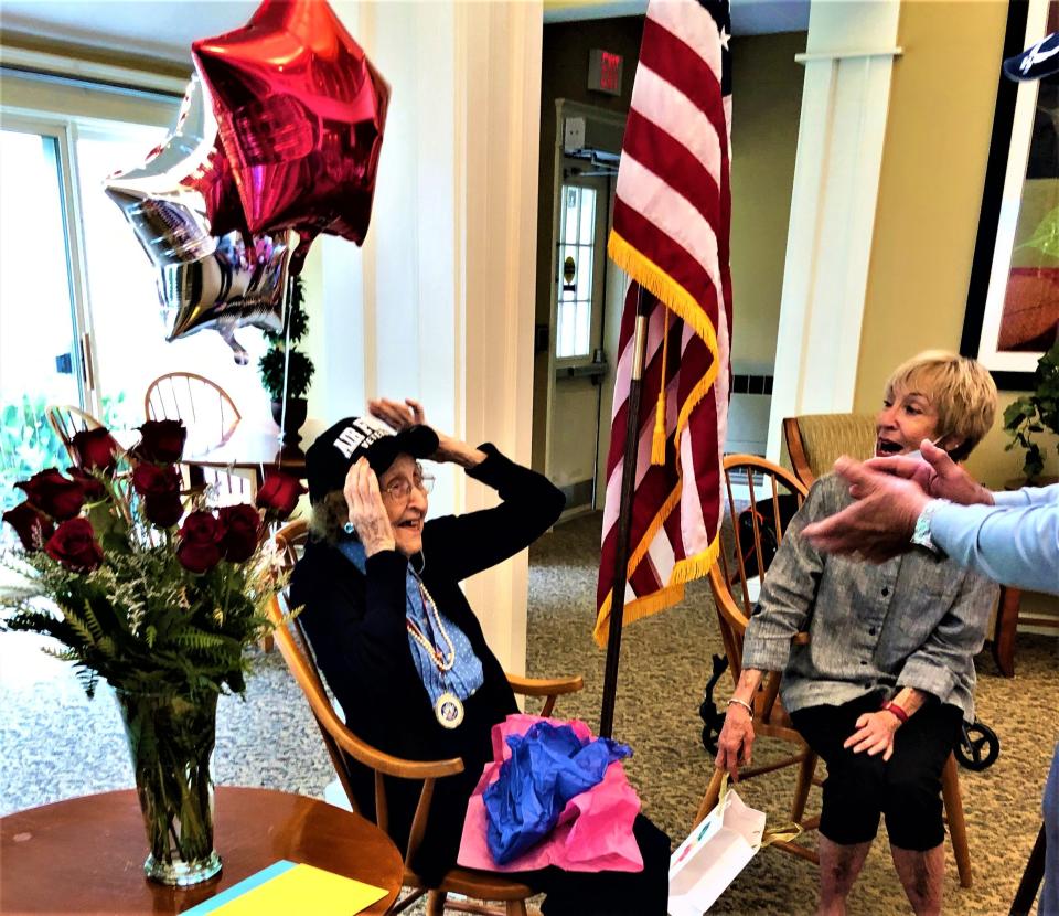 Gladys Laughland is surprised with an Air Force veterans hat at her 104th birthday at Wingate Residences at Silver Lake assisted living in Kingston. Her daughter Linda Ryan, of Marshfield, is on the right.