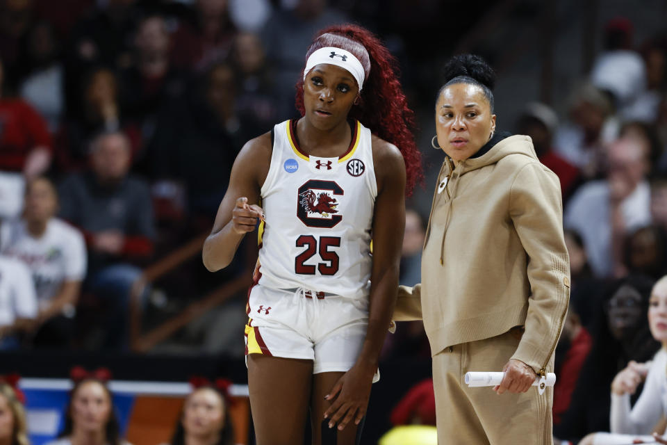 South Carolina head coach Dawn Staley, right, talks to guard Raven Johnson (25) during the first half of a second-round college basketball game against North Carolina in the women's NCAA Tournament in Columbia, S.C., Sunday, March 24, 2024. (AP Photo/Nell Redmond)