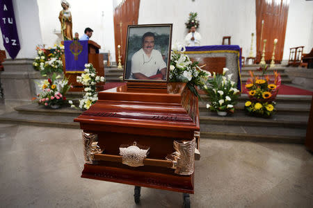 A framed photograph of slain journalist Ricardo Monlui is seen placed over his coffin during his funeral mass at a church in Cordoba, in the Mexican state of Veracruz, Mexico March 20, 2017. REUTERS/Yahir Ceballos