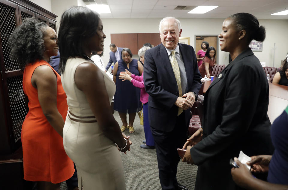 In this Sept. 19, 2018, photo, former Tennessee Democratic Gov. Phil Bredesen talks with participants after a roundtable discussion in Nashville, Tenn. Bredesen is a Democrat. But he'd rather you not mention that. So far his strategy of trying to maintain "independence from all of the national Democratic stuff" is working for the two-term Tennessee governor now running for Senate. (AP Photo/Mark Humphrey)