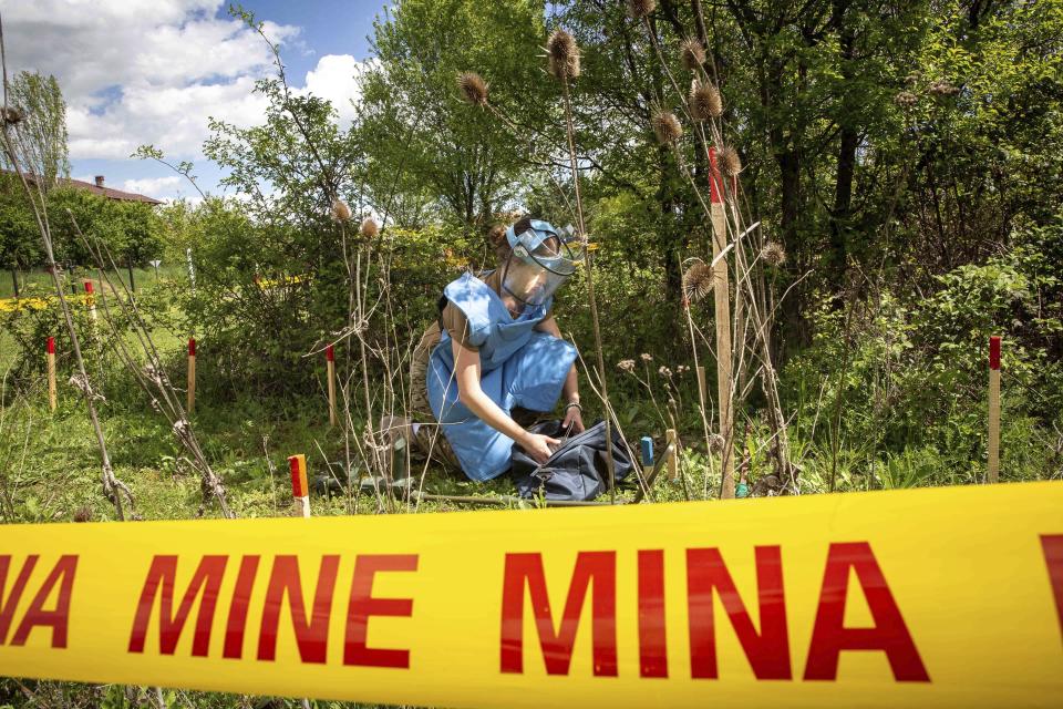 Anastasiia Minchukova unpacks tools during a training session for a group of Ukrainian female emergency services personnel for specialist training in explosive ordnance disposal and survey training in western Kosovo city of Peja on Monday, April 25, 2022. Six Ukrainian women have started to be trained in Kosovo to dispose of explosive ordnance that have contaminated their country invaded by Russia. (AP Photo/Visar Kryeziu)