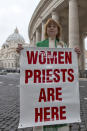 FILE - In this photo taken on Thursday, March 7, 2013 Janice Sevre-Duszynska poses with a banner at the Vatican. Roman Catholic Womenpriests was founded in Germany in 2002. Pope Francis said in an interview with The Associated Press at The Vatican on Tuesday, Jan. 24, 2023, that there's a risk that what could be a trailblazing reform process in the German church could become "ideological." (AP Photo/Andrew Medichini, file)