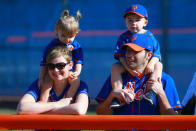 <p>Young fans of the New York Mets, perched on the shoulder of their parents, watch players work out during spring training in Port St. Lucie, Fla., Feb. 23, 2018. (Photo: Gordon Donovan/Yahoo News) </p>