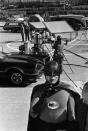 <p>Adam West, star of the television series “Batman,” stands beside the Batmobile and shows off his “Bat Radio,” on the Hollywood set for the series during filming of an episode, March 18, 1966. (Photo: AP) </p>