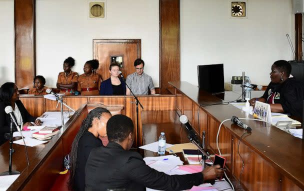 PHOTO: American couple Nicholas Spencer and Mackenzie Leigh Mathias Spencer, both 32, stand in the dock at Buganda road court, where they were charged with torturing a 10-year-old, in Kampala, Uganda, on Dec. 14, 2022. (Abubaker Lubowa/Reuters)