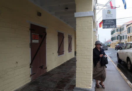 A woman walks past a building for rent in Christiansted, on the outskirts of St Croix, U.S. Virgin Islands June 29, 2017. REUTERS/Alvin Baez