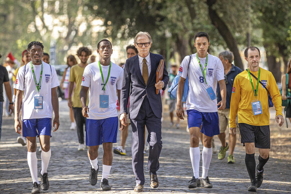 This image released by Netflix shows, from left, Sheyi Cole, Micheal Ward, Bill Nighy, Kit Young and Tom Vaughan-Lawlor in a scene from "The Beautiful Game." (Alfredo Falvo/Netflix via AP)