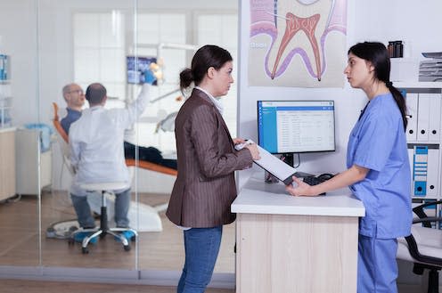 <span class="caption">Those lucky enough to get an appointment often have to wait months for their care.</span> <span class="attribution"><a class="link " href="https://www.shutterstock.com/image-photo/woman-dentistiry-clinic-asking-information-fill-1960682797" rel="nofollow noopener" target="_blank" data-ylk="slk:DC Studio/ Shutterstock;elm:context_link;itc:0;sec:content-canvas">DC Studio/ Shutterstock</a></span>
