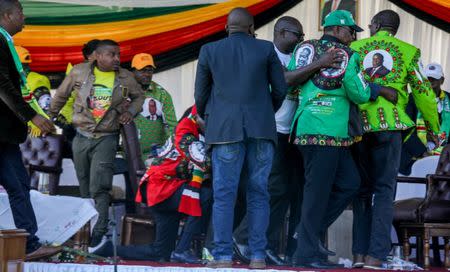 Zimbabwe's vice president Constantino Chiwenga is escorted from the stage after an explosion during a rally by Zimbabwean President Emmerson Mnangagwa in Bulawayo, Zimbabwe June 23, 2018. Tafadzwa Ufumeli/via REUTERS