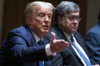 Attorney General William Barr listens as President Donald Trump speaks during a meeting with Republican state attorneys general about social media companies, in the Cabinet Room of the White House, Wednesday, Sept. 23, 2020, in Washington. (AP Photo/Evan Vucci)