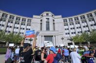 FILE- In this July 18, 2018 file photo demonstrators rally outside the Michigan Hall of Justice in Lansing, Mich. Fresh off sweeping electoral victories a decade ago, governors and lawmakers in several states used new census data to redraw voting districts for Congress and state legislatures that were intended to help their party remain in power for years to come. Those efforts largely paid off, particularly for Republicans. An Associated Press analysis designed to detect the effects of gerrymandering shows that Republicans enjoyed a greater political advantage in more states over the past decade than either party had over the past 50 years. (Dale G. Young/Detroit News via AP, File)