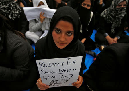 A student holds a placard as she participates in a signature campaign to protest against the rape of an eight-year-old girl in Kathua, near Jammu, in Srinagar April 18, 2018. REUTERS/Danish Ismail