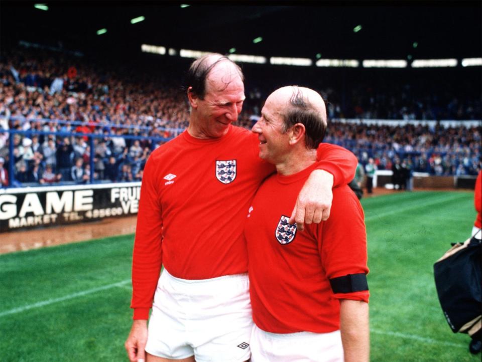 The Charlton brothers Jack and Bobby embrace at the end of a charity match at Elland Road, Leeds, in 1985 (Getty)