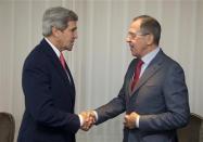U.S. Secretary of State John Kerry (L) and Russia's Foreign Minister Sergei Lavrov shake hands during a photo opportunity prior to their meeting, in Geneva November 23, 2013. REUTERS/Carolyn Kaster/Pool