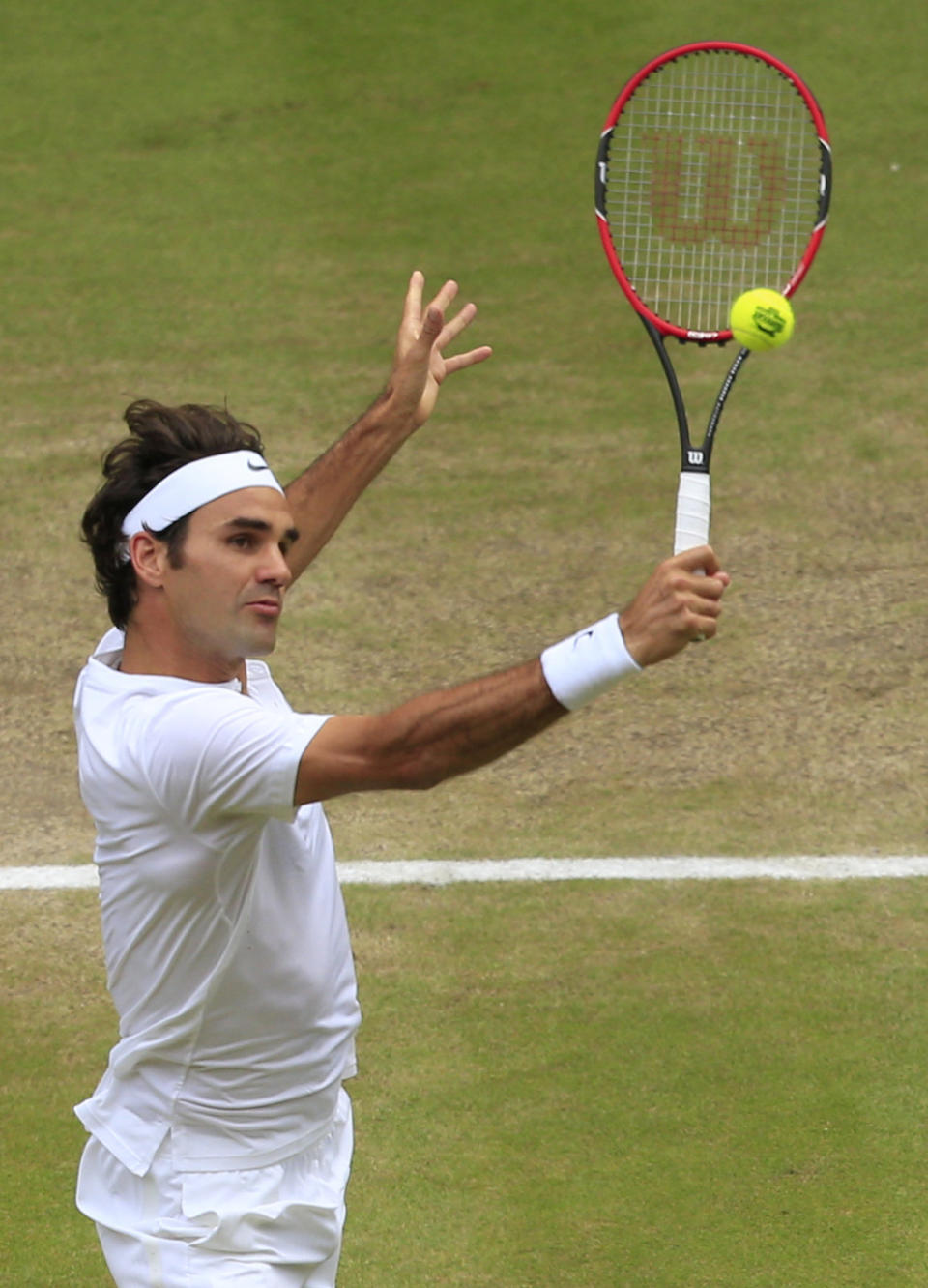 Roger Federer of Switzerland returns to Novak Djokovic of Serbia during the men's singles final at the All England Lawn Tennis Championships in Wimbledon, London, Sunday July 12, 2015. (Jonathan Brady/Pool Photo via AP)