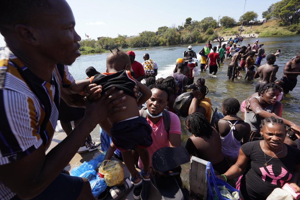 Haitian migrants use a dam to cross to and from the United States from Mexico, Friday, Sept. 17, 2021, in Del Rio, Texas. Thousands of Haitian migrants have assembled under and around a bridge in Del Rio presenting the Biden administration with a fresh and immediate challenge as it tries to manage large numbers of asylum-seekers who have been reaching U.S. soil. (AP Photo/Eric Gay)