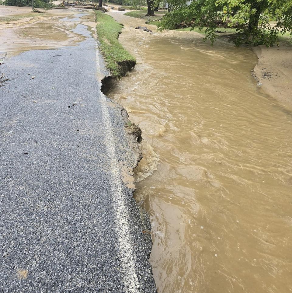 Flooding and a heavily damaged road near Bat Cave around Lake Lure, North Carolina, on Friday following the impacts of Storm Helene (Helen Pace)