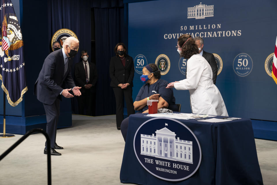 President Joe Biden talks to Linda Bussey before she received a vaccination, during an event to commemorate the 50 millionth COVID-19 shot, in the South Court Auditorium on the White House campus, Thursday, Feb. 25, 2021, in Washington. (AP Photo/Evan Vucci)