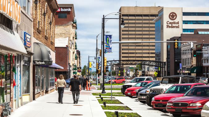 Topeka, KS, USA - April 28, 2016: A few people walking on a sunny spring day in Topeka historic downtown.