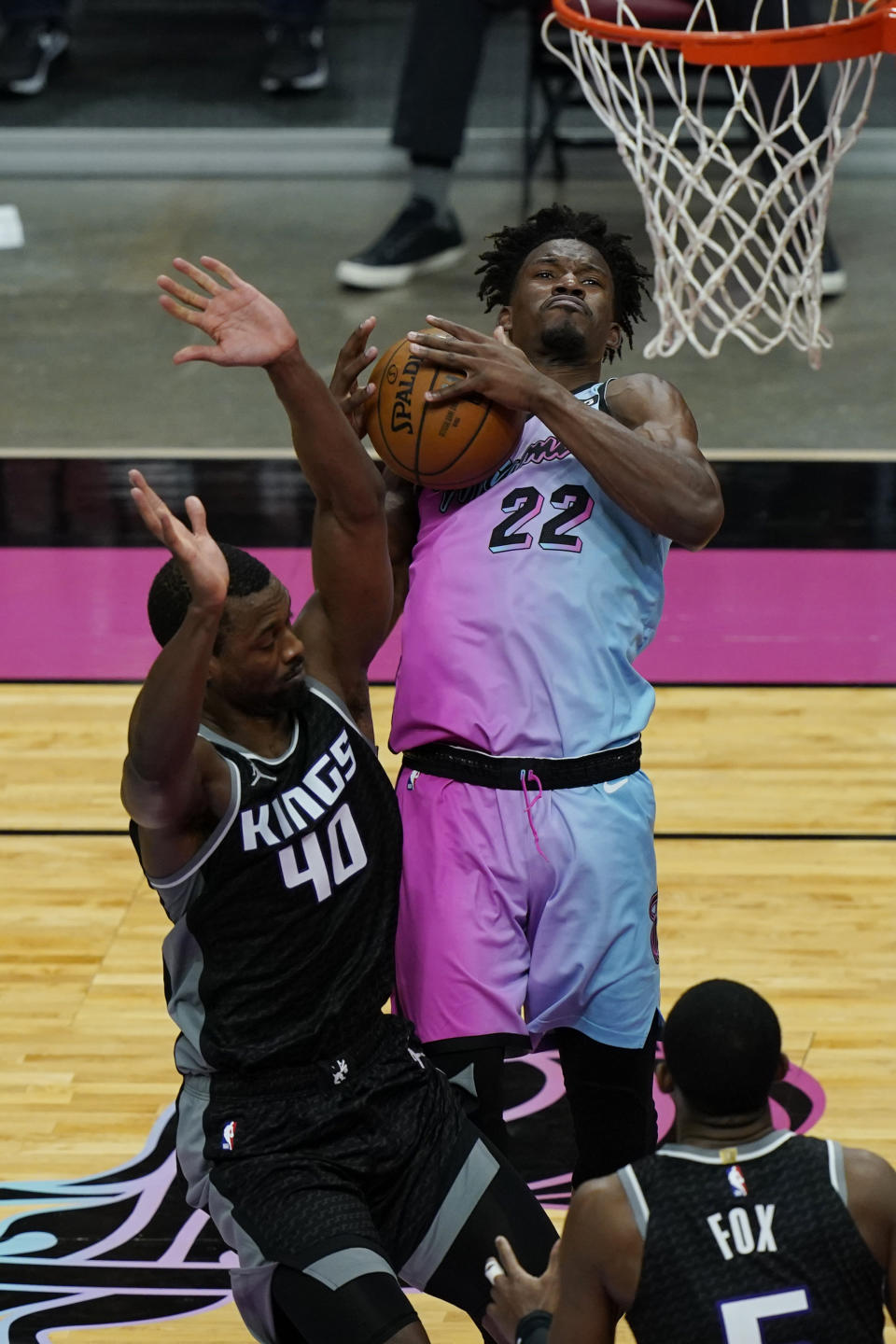Sacramento Kings forward Harrison Barnes (40) fouls Miami Heat forward Jimmy Butler (22) as he drives to the basket during the second half of an NBA basketball game, Saturday, Jan. 30, 2021, in Miami. (AP Photo/Marta Lavandier)