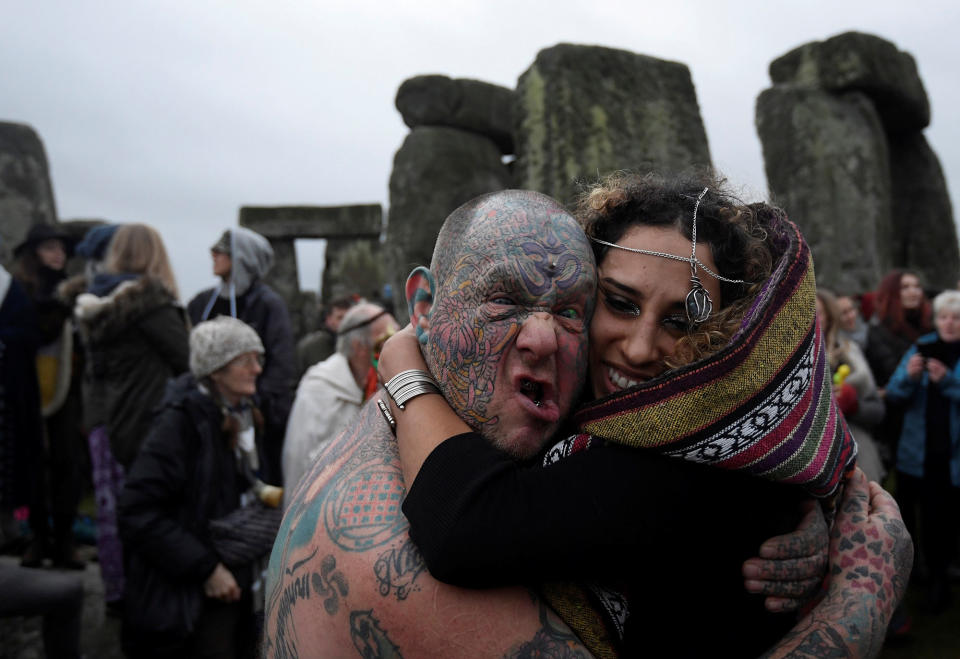 Winter solstice revelers hug at Stonehenge near Amesbury, Britain