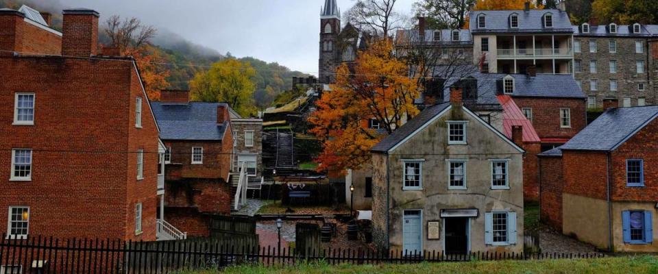 Beautiful view of Harpers Ferry civil war historic town in west Virginia on a misty day during the fall season with colored tree leaves by the Potomac and Shenandoah river