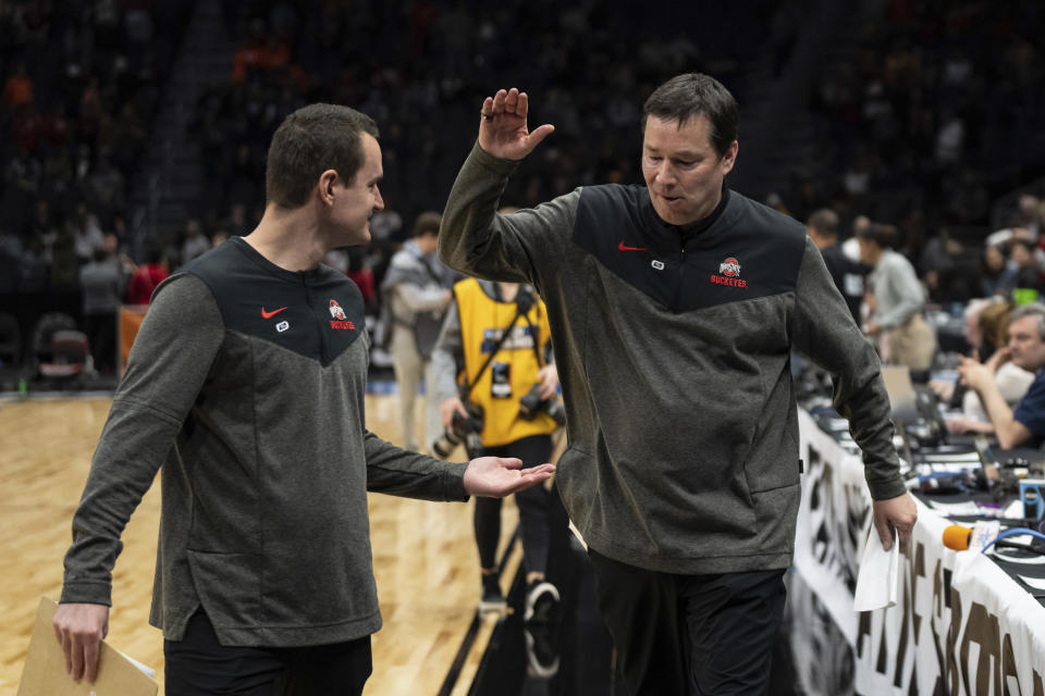 Ohio State head coach Kevin McGuff, right, celebrates with staff member Reid Guzdanski after a Sweet 16 college basketball game of the NCAA Tournament against UConn, Saturday, March 25, 2023, in Seattle. . (AP Photo/Stephen Brashear)