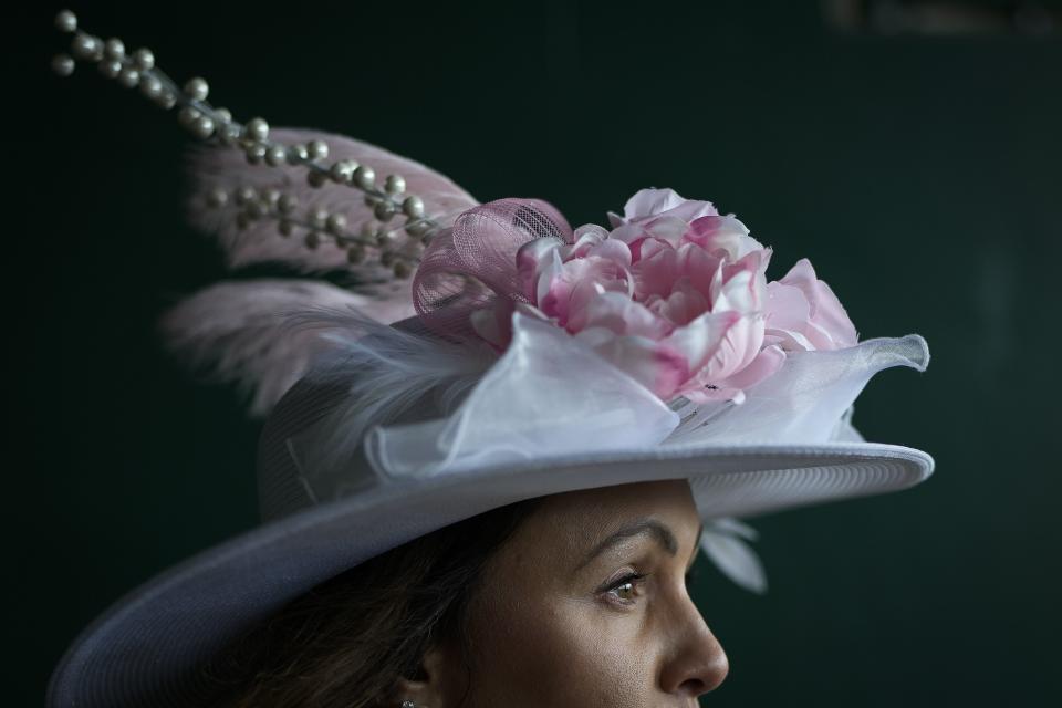 A woman walks to her seat on the day of the 149th running of the Kentucky Derby at Churchill Downs Saturday, May 6, 2023, in Louisville, Ky. | Bryan Woolston, Associated Press