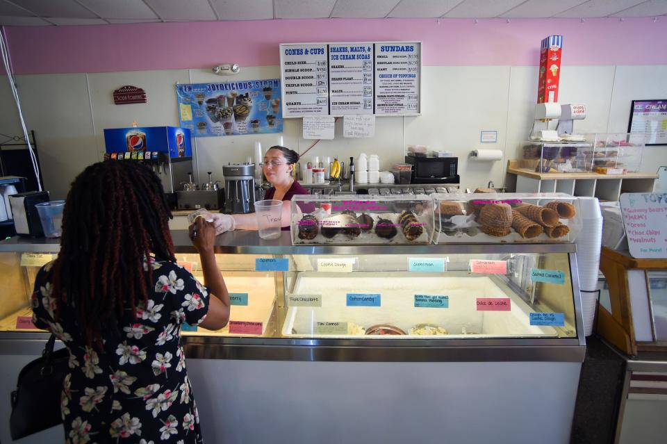 A customer chooses from a variety of flavors July 15 at Joy’s Ice Cream in Fort Pierce.