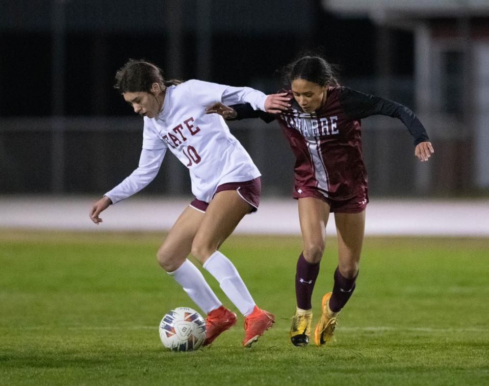 Julianne Cowley (10) tries to hold off Cici Buffalino (6) while controlling the ball during the Tate vs Navarre girls soccer game at Navarre High School on Wednesday, Jan. 3, 2024.