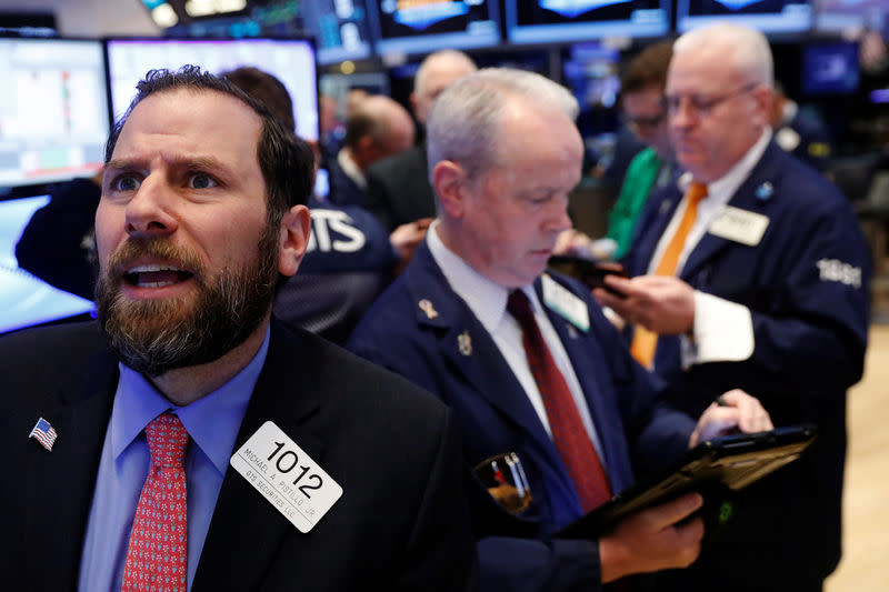 Traders work on the floor of the New York Stock Exchange (NYSE) shortly after the opening bell in New York, U.S., March 22, 2017. REUTERS/Lucas Jackson