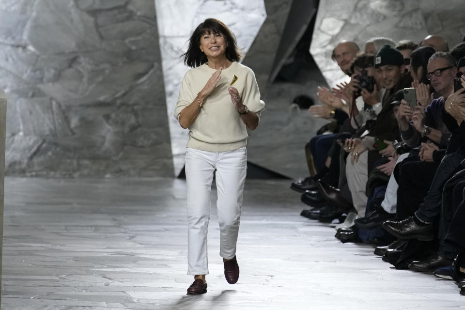 Designer Veronique Nichanian accepts applause at the end of the Hermes menswear Fall-Winter 2023-24 collection presented in Paris, Saturday, Jan. 21, 2023. (AP Photo/Christophe Ena)