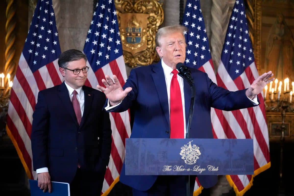 Donald Trump and Mike Johnson appear together at Mar-a-Lago on 12 April (AP)