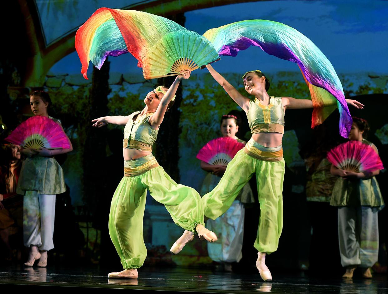 Rainbow fans Hadley Himes and Jaclyn Lyall dance in Aladdin's palace scene.