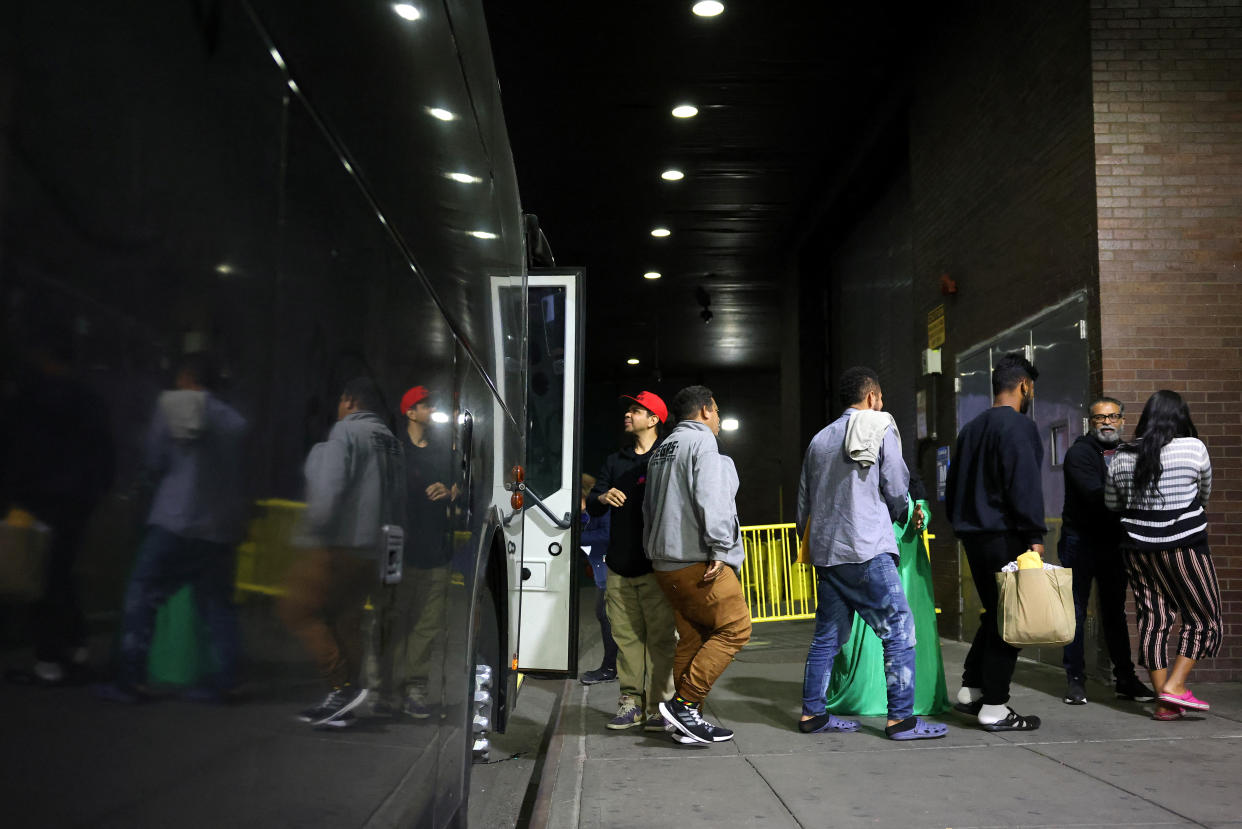 Migrants arriving from Texas by bus disembark at the Port Authority bus terminal in New York City on May 10.