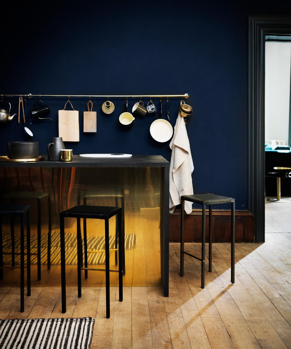 <p> Kitchen color ideas in dark blue with wooden flooring and a brass island with black stools. </p> <p> With its warm, burnished lustre, brass is once again in the ascendant, lending a polished edge to interiors.&#xA0; </p> <p> A dark background is ideal for showing off the gleaming beauty of brass. Here, it forms a counterpoint to a statement mirror-like panel that adds a glamorous note to a modern kitchen island. </p>