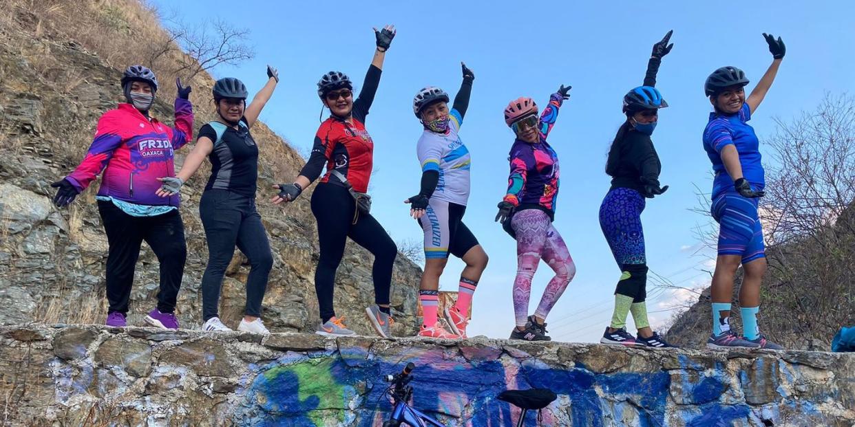 group portrait on a wall with a bike of fridas en bici