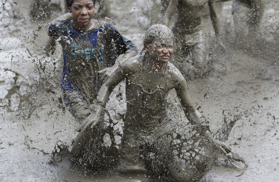 <p>Kids participate in races during Mud Day at the Nankin Mills Park, July 11, 2017 in Westland, Mich. (Photo: Carlos Osorio/AP) </p>