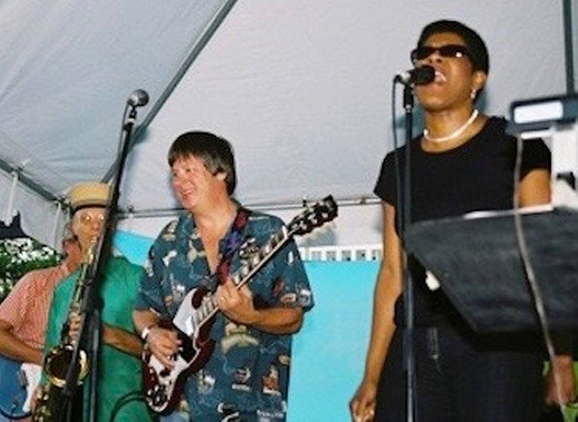 Author Tananarive Due singing on stage with Dave Barry at the Miami Book Fair with the Rock Bottom Remainders, a classic rock super group of published writers.