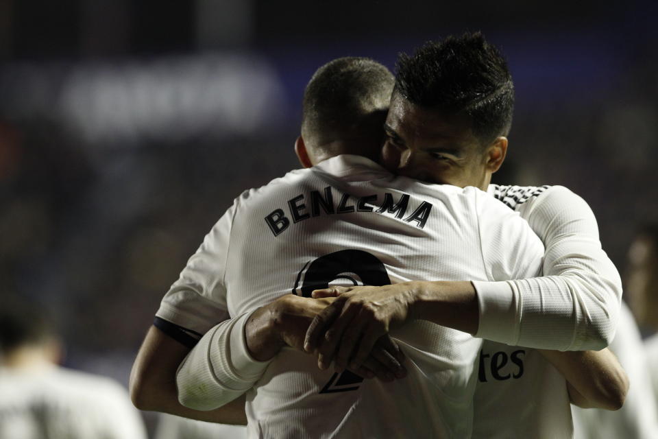 Real forward Karim Benzema celebrates with his teammate Casemiro after scoring his side's opening goal during a Spanish La Liga soccer match at the Ciutat de Valencia stadium in Valencia, Spain, Sunday, Feb. 24, 2019.(AP Photo/Alberto Saiz)