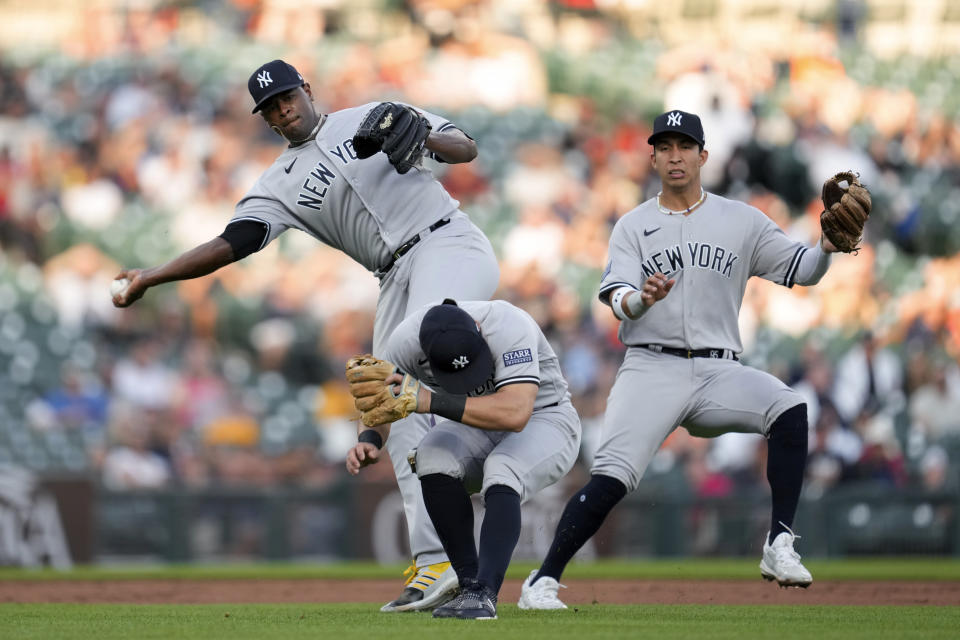 New York Yankees pitcher Luis Severino, left, throws to first base on a Detroit Tigers' Miguel Cabrera line drive single as shortstop Anthony Volpe ducks as Oswaldo Cabrera, right, looks on in the second inning of a baseball game, Monday, Aug. 28, 2023, in Detroit. (AP Photo/Paul Sancya)