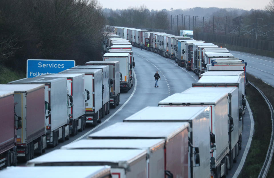 Lorry drivers walk about on the M20 in Kent where freight traffic is parked up near to Folkestone services whilst the Port of Dover remains closed.