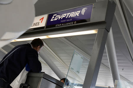 A traveler speaks to an agent at an Egypt Air counter at JFK International Airport in New York, U.S., March 21, 2017. REUTERS/Lucas Jackson