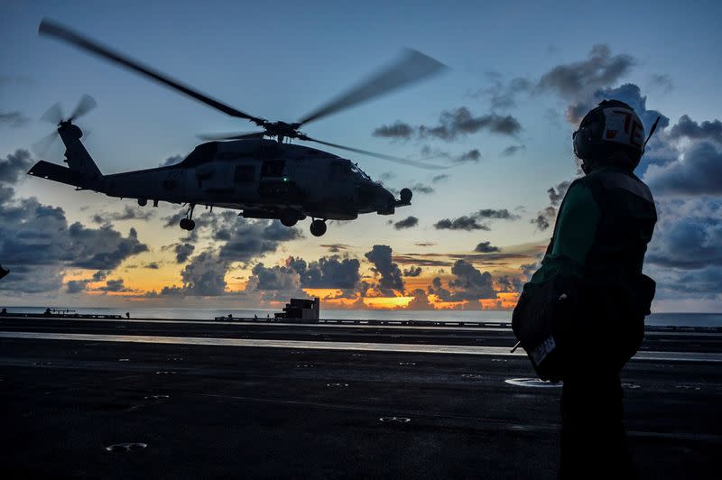 FILE PHOTO: Sea Hawk helicopter launches during flight operations aboard the U.S. Navy aircraft carrier USS Ronald Reagan in the South China Sea