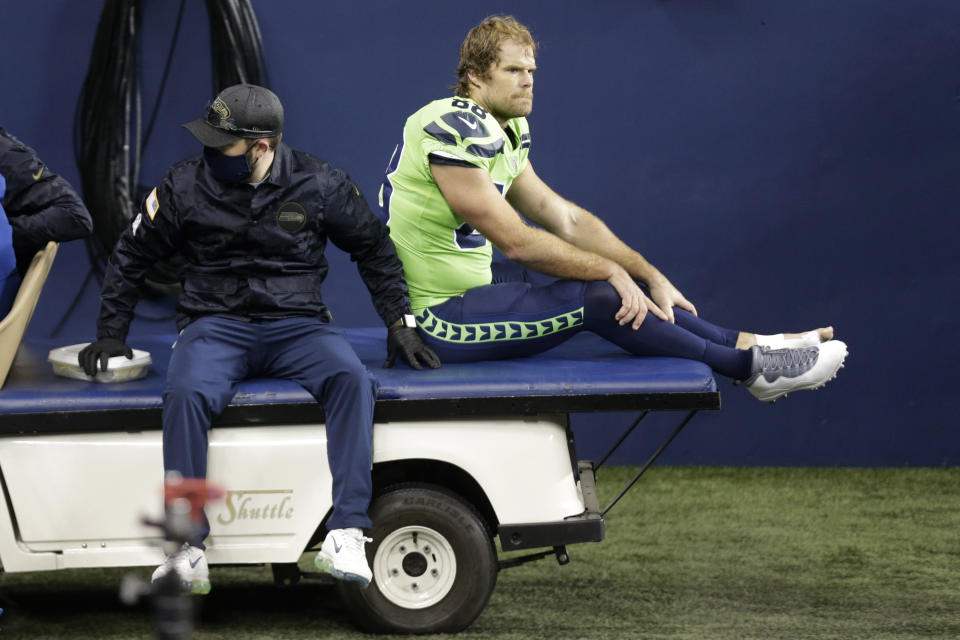 Seattle Seahawks tight end Greg Olsen (88) is taken off the field on a cart after going down with an injury against the Arizona Cardinals during the second half of an NFL football game, Thursday, Nov. 19, 2020, in Seattle. (AP Photo/Lindsey Wasson)