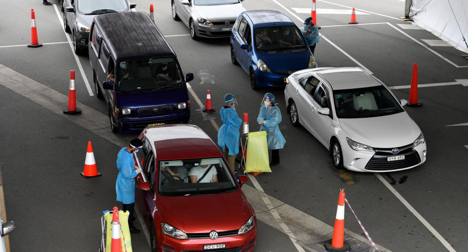 Cars queue as people wait to recieve a Covid test at a drive through testing facility at Sydney International Airport on December 22, 2021. Source: AAP/Dan Himbrechts