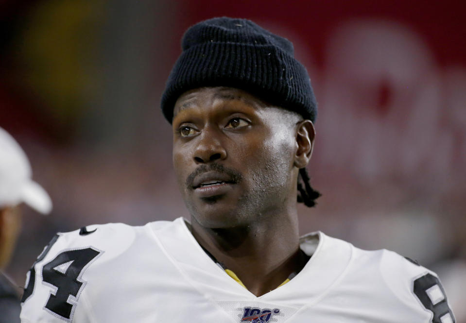 FILE - In this Aug. 15, 2019, file photo, Oakland Raiders wide receiver Antonio Brown watches from the sidelines during the second half of the team's NFL preseason football game against the Arizona Cardinals in Glendale, Ariz. Brown, who was released by the Raiders last week and is now with the New England Patriots, has been accused of rape by a former trainer. Britney Taylor says Brown sexually assaulted her on three occasions, according to a lawsuit filed Tuesday, Sept. 10, in the Southern District of Florida. Brown has denied the allegations (AP Photo/Rick Scuteri, File)